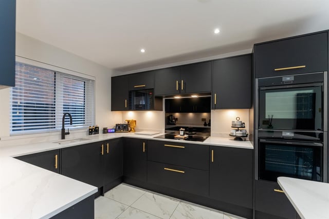 The kitchen has a matching breakfast bar area; inlaid 1.5 bowl, colour coded sink unit; integrated, touch screen, Neff induction hob with glass splashback and extractor hood over; integrated Neff double ovens, and Bosch microwave oven and dishwasher.