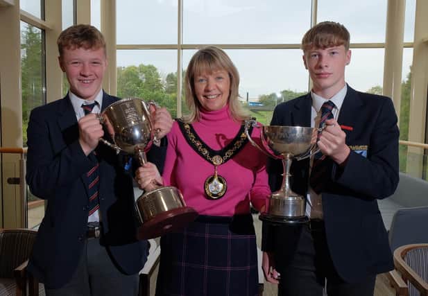 Lord Mayor of Armagh City, Banbridge and Craigavon Borough Council, Alderman Margaret Tinsley with Craigavon Senior High School team captain Samuel Ruddell, holding the U16 Danske Bank Ulster High School Trophy and Dylan Adamson with the Ulster High Schools Pollock Cup