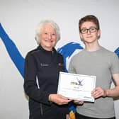 Dromore gymnast Oscar Hall is pictured collecting his award from Lady Mary Peters. Pic credit: Mary Peters Trust