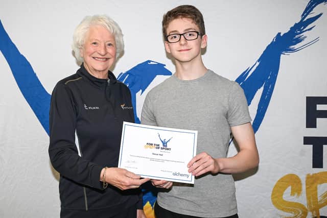 Dromore gymnast Oscar Hall is pictured collecting his award from Lady Mary Peters. Pic credit: Mary Peters Trust