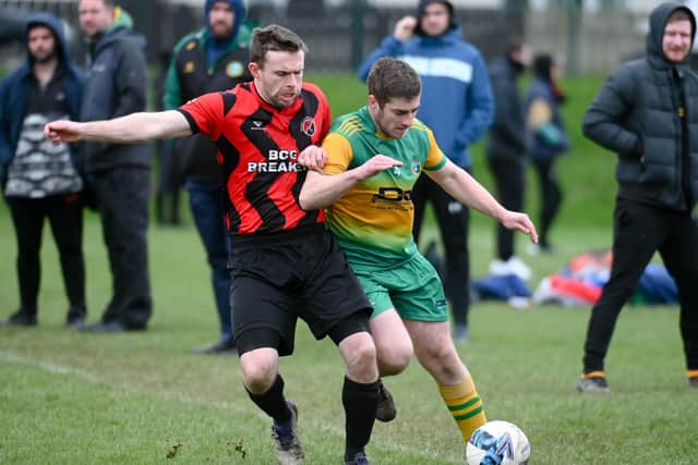 Ballyholland's Christopher Havern holds off a challenge from Ballybot fullback David Muphy at Jennings Park. BM2405400