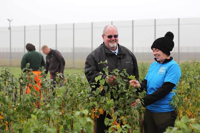 Pictured among some of the trees growing in the prison are Malcolm McClenaghan, Governor in charge of Activities, and Aisling Gribbin from the Causeway Coast and Glens Heritage Trust