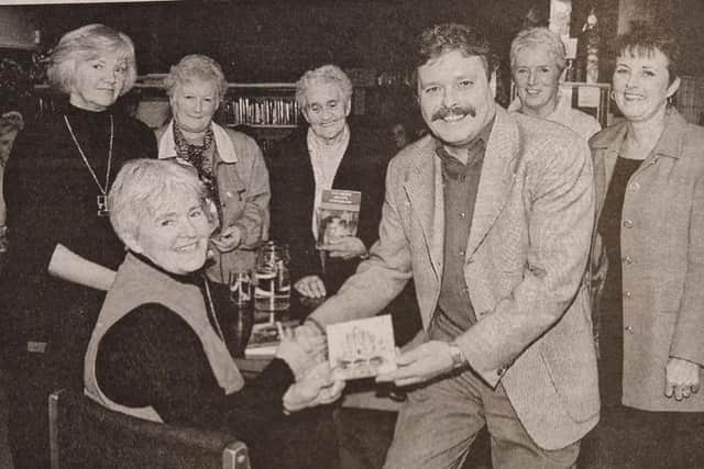 Danny Doran presents a copy of his Song for the Milleniun to best selling author Alice Taylor who took part in the last of the series of the 'Books Across The Border' community centre at Newry Library.