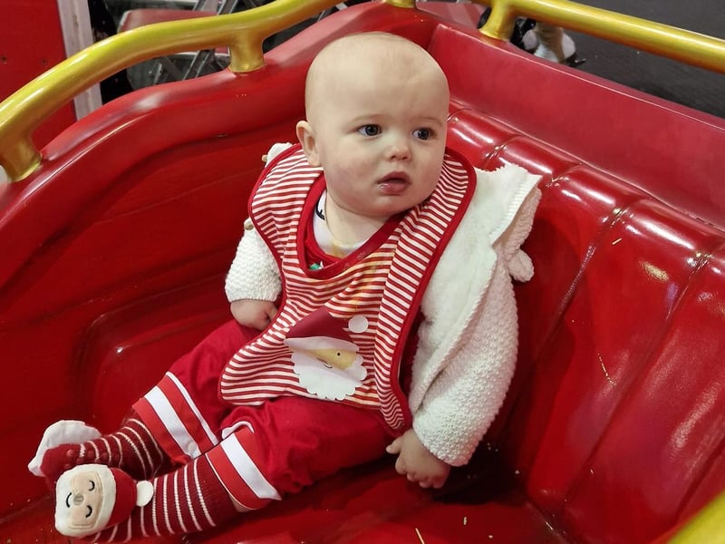 Enjoying a ride in Santa's sleigh.