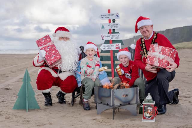 Pictured at the launch of the Christmas events programme is Mayor of Causeway Coast and Glens, Councillor Steven Callaghan with Santa, Fraser Caithness (9) and Hugo Caithness (6). Credit Causeway Coast and Glens Council