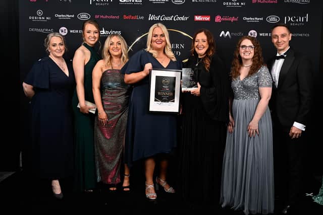 Jillian M Saulters and team, from Larne Dental Centre, are presented with the award for Cosmetic Dental Practice of the Year by Rob Wilkins, on behalf of event partner BF Mulholland.
