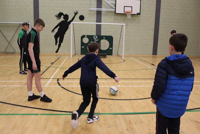 Prospective pupils trying their best to score goals in PE
