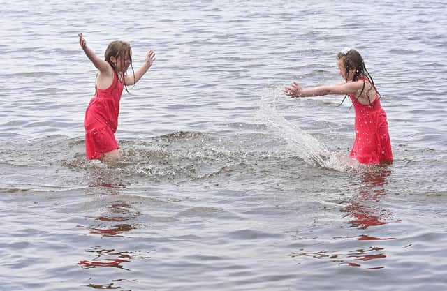 Twins Ellie and Eireann enjoying the weather at Lough Shore Park in Antrim.