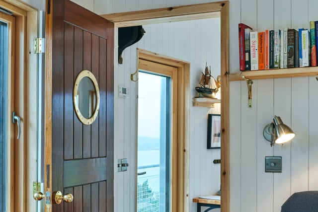 The cabin features numerous design flourishes, including porthole doors.