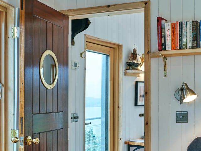 The cabin features numerous design flourishes, including porthole doors.