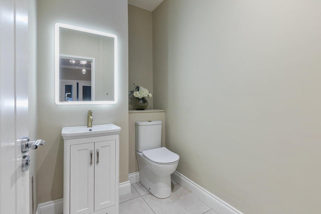 Off the hallway there is a cloakroom with wc, wash hand basin and vanity unit, illuminated mirror and has a tiled floor.