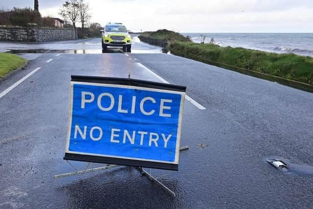 Police at the Coast Road on Friday following a landslide which made a stretch of the route impassable. Picture: Colm Lenaghan / Pacemaker Photo