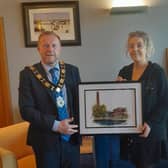 Dionne Pollock presents the Mayor of Antrim and Newtownabbey, Ald Stephen Ross, with a digital print of Mossley Mill.