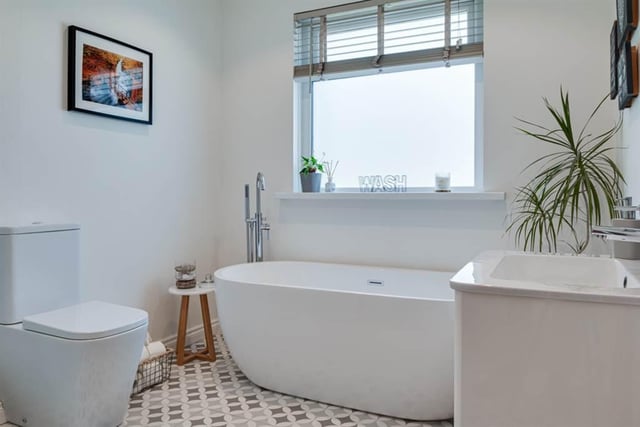 Family bathroom with contemporary white suite.