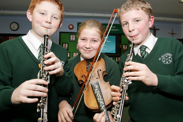 Niall Gallagher, Nicole Pollock and Owen Beckett, members of the St Aloysius Primary School orchestra, tune up their instruments for the school's parents' night in 2009
