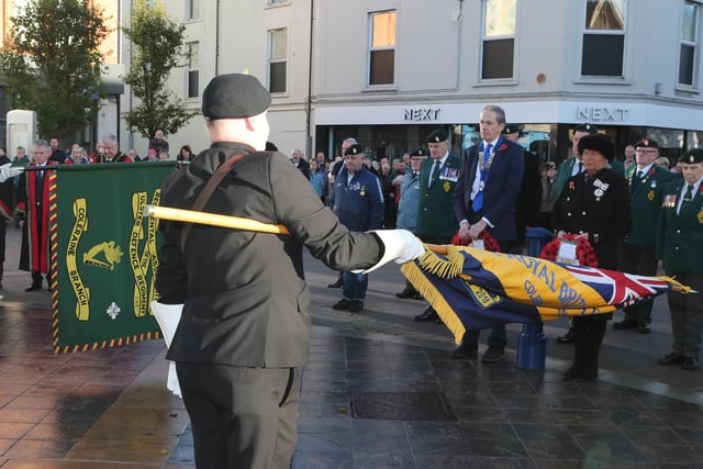 Lowering the standards to mark Armistice Day November 11 at Coleraine War Memorial
