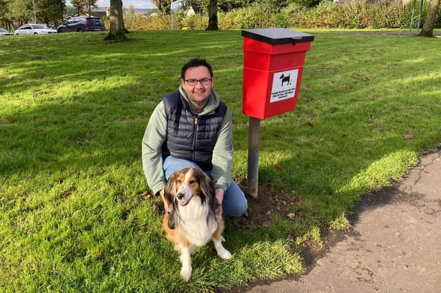 Ballymoney councillor Lee Kane, alongside Ruby, has welcomed the replacement dog waste bin. Credit Lee Kane