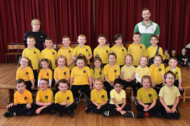 P2 pupils of Hart Memorial Primary School pictured before their exercise session with teacher, Judith Lee, P2LM, and Northern Ireland and Ireland swimmer, David Thompson. PT11-221.