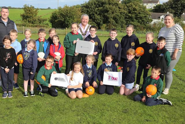 The Mayor of Causeway Coast and Glens Borough Council, Councillor Ivor Wallace and Good Relations Officer Gerard McIlroy pictured with pupils from St Olcan’s Primary School, Armoy and Straidbilly Primary School who took part in the joint schools event.