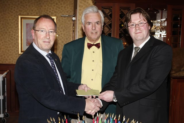 FUNDRAISER...John Davidson, secretary of Coleraine Lions Club, presents a cheque to Gary Gamble, Belfast City Hospital in 2008, who received it on behalf of the N.I. Kidney Research Fund. Included is Winston Wallace, a patient at the hospital, who helped organise the fundraising event.