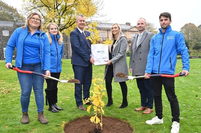 Former Environment Minster Edwin Poots presents the Deputy Mayor, Councillor Leah Smyth and Matt McDowell, director of Parks and Leisure, Antrim and Newtownabbey Borough Council, with a Hiroshima Survivor Tree sapling.