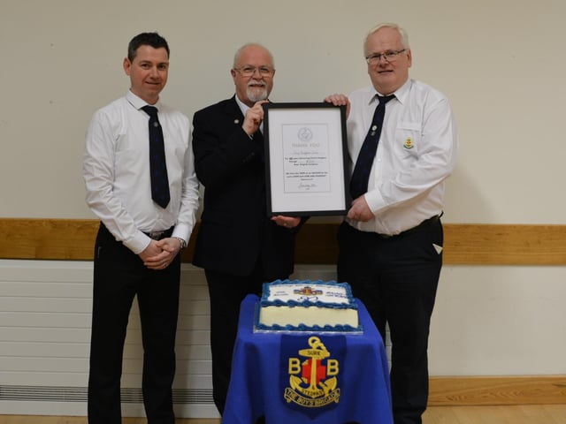 Guest speaker Glen Millar representing the Boys Brigade in NI, presenting the Rev R Gaston and Officer Mr A. Bolton with a special certificate to celebrate the 80th Anniversary.