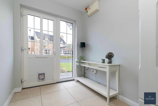 The bright entrance hall has an attractive part glazed door with side panel and tiled flooring.