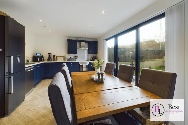 Modern kitchen with patio doors to rear garden.