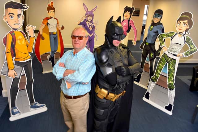 Batman and former Housing Executive Chair Professor Peter Roberts encourage pupils to be eco-aware.