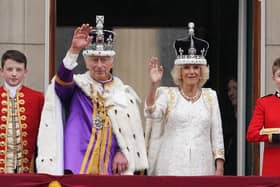 King Charles III and Queen Camilla on the balcony of Buckingham Palace following the coronation on May 6, 2023. Picture: Owen Humphreys/PA Wire.