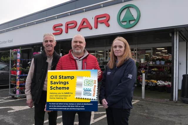 Chair of Environmental Services Councillor Martin Gregg (C) visited one of the first Oil Stamp Saving Scheme retailers Cordners Spar in Dundonald with Stuart Cordner (L) and Brenda Harbinson (R), Home Assessment Officer for the Affordable Warmth Scheme.