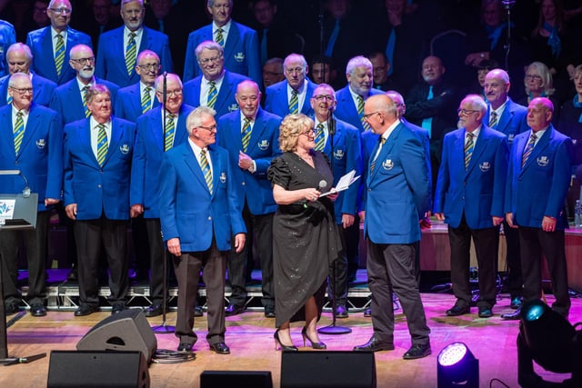 Compere Laura Kerr chats with members of Barry Male Voice Choir