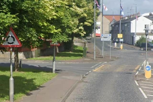 On the approach into Banbridge from the Rathfriland Road, the sign denoting a roundabout is partially obscured, while the sign warning of a pedestrian crossing is almost invisible (photo taken in July 2023). Credit: Google