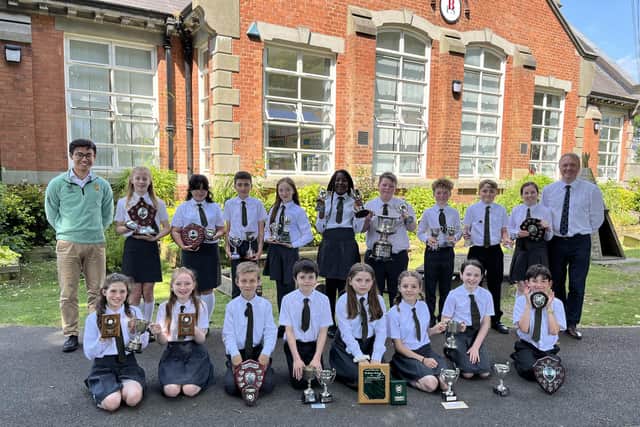 Primary 7 children with the awards they were presented with at the Leavers' Assembly. Also included is principal Mr Colin Elliott and guest speaker Chenyang Li. Pic credit: Brownlee Primary School