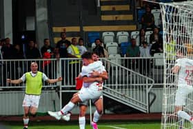 Larne's Lee Bonis celebrates with goalscorer Matty Lusty as the Irish Premiership champions defeated FC Ballkani 1-0 in the first leg of their UEFA Conference League qualifier in Pristina