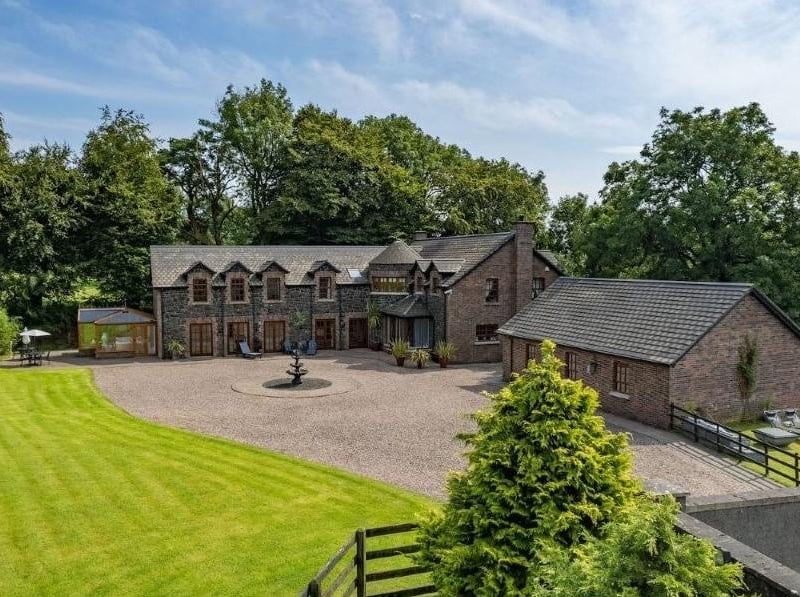Nestled within the beautiful countryside of Glenwherry, 'The Brae' occupies an elevated setting within grounds extending to approximately 3.3 acres. The five bedroom residence is completed in basalt stone and brick, with surrounding gardens, garaging, a courtyard, stable block, arena and two adjoining paddocks. To the interior is a hallway with a central oak staircase, lounge, dining room, recently installed Johanna Montgomery designed kitchen, and a sun porch and snug. An inner hallway leads to a circular designed cloaks/WC with a hatch opening to a wine cellar beneath. A study is also tucked off this area with a superb family room/entertainment room, opening to a conservatory positioned to the rear. On the first floor are five bedrooms and a beautiful bathroom, completed in Travertine stone tiling. The principal bedroom benefits from a fitted dressing area and ensuite, with a further bedroom benefiting from an ensuite bathroom. A games room is positioned to the rear, providing an ideal space for additional entertaining. This magnificent home is on the market for offers around £650,000 with Lynn + Brewster.
