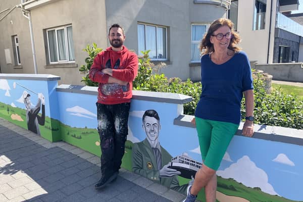 Artist Ian Lowry and host Maureen Davidson pictured after the golfing greats mural was unveiled at her Portstewart B&B.