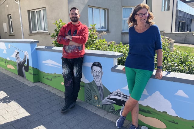 Artist Ian Lowry and host Maureen Davidson pictured after the golfing greats mural was unveiled at her Portstewart B&B.