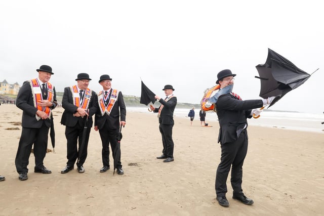 Brother Samuel Douglas, District Lay Chaplain from the Loughbrickland District pictured having trouble with his umbrella on the beach.