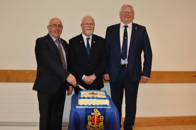 Mr W Campbell, Past Captain, Rev R Gaston and Mr Ian Bolton Past Captain, cutting the cake at the 80th anniversary service.