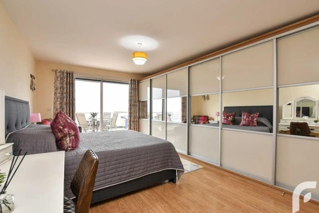 Bedroom with sliderobes for ample storage space and uPVC doors opening to balcony area.