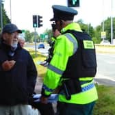 Pastor Clive Johnston speaking to a police officer in Coleraine.