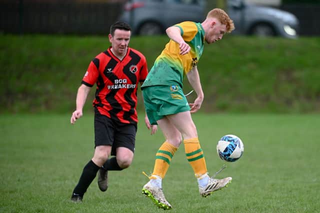 Ryan Fearon gets the ball down as Ballybot midfielder Barry Garvey closes in on Saturday. BM2405403