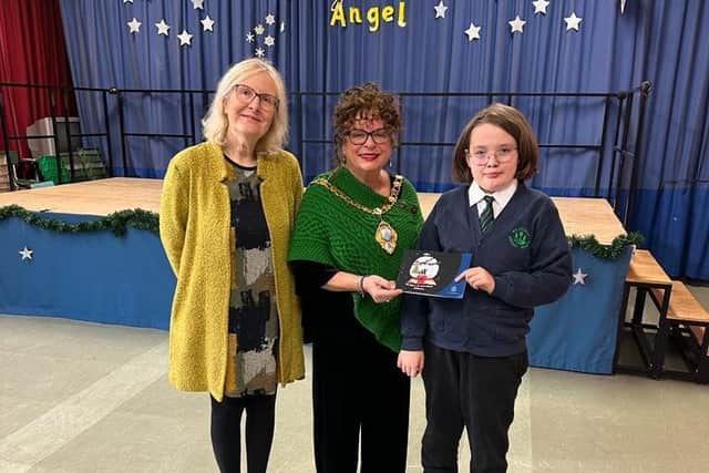 The Mayor formally presented the card and a gift to the winner at their primary school.  Photo: Mid and East Antrim Borough Council