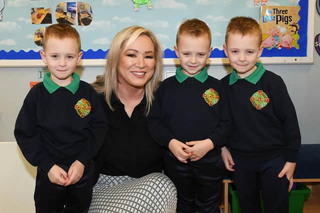 First Minister Michelle O’Neill pictured with triplets Jake, Jordan and Kyle who are pupils at Primate Dixon, during her visit to her former primary school. Credit: Submitted