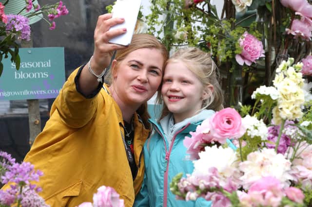 Mum Emma with daughter Aoibheann McPeake take a photo amongst the blooms at Garden Show Ireland on Saturday.