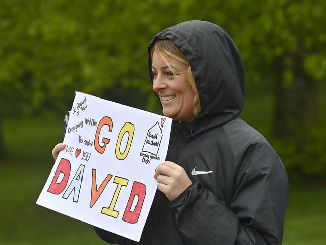Cheering on from the pavement.