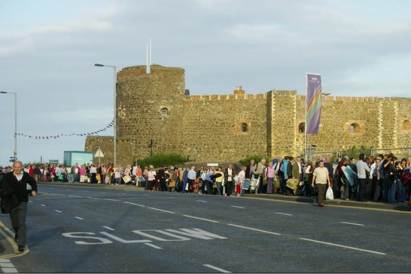 In the queue for Proms in the Park against the backdrop of Carrickfergus Castle.