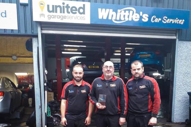 Paul Whittles, owner of Whittles Garage in Portadown, Co Armagh with his two mechanics Radi and Julio.
