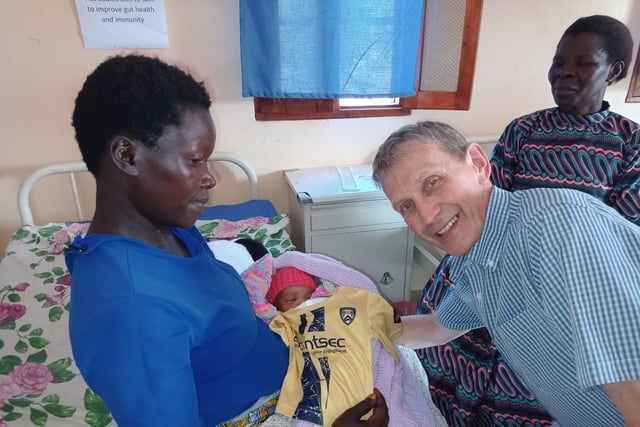 Rev Robert McMullan recruiting a new-born Coleraine fan in the maternity hospital in Dikka in Uganda.
